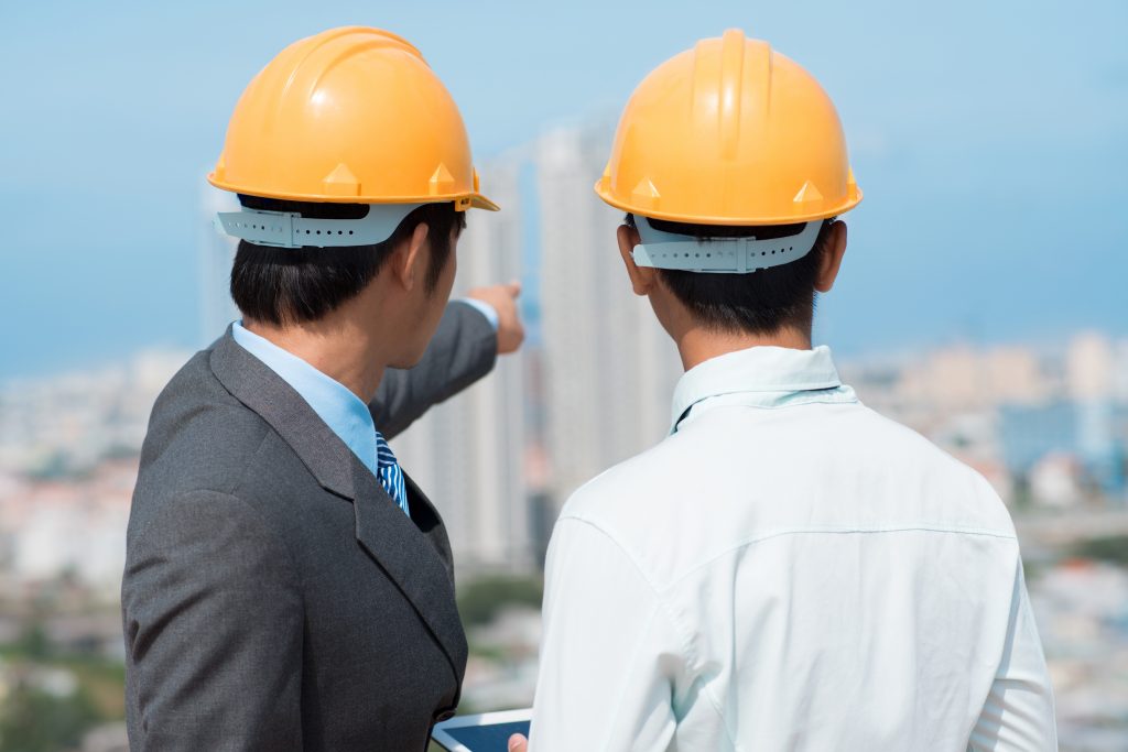 Developers looking over an urban panorama choosing an appropriate construction site